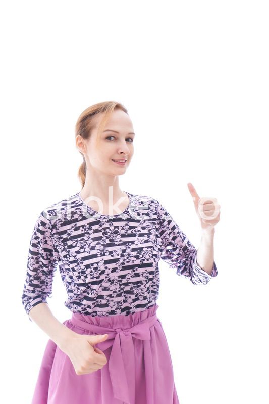 グッドサインをする私服を着た若い女性