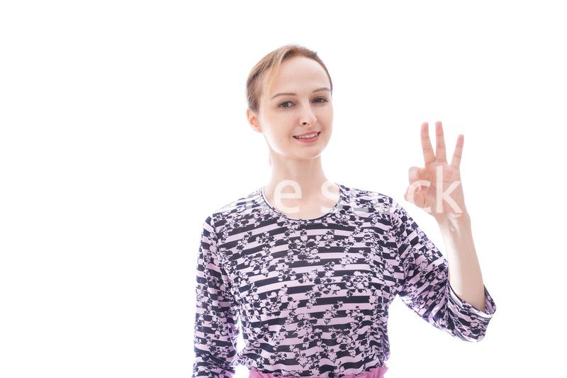 グッドサインをする私服を着た若い女性