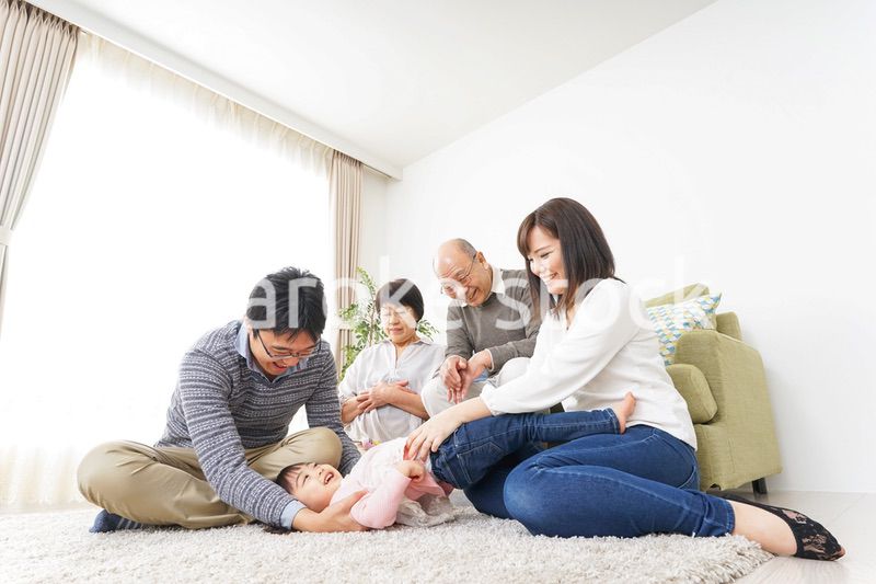 家族で犬と遊ぶ幸せな三世代ファミリー