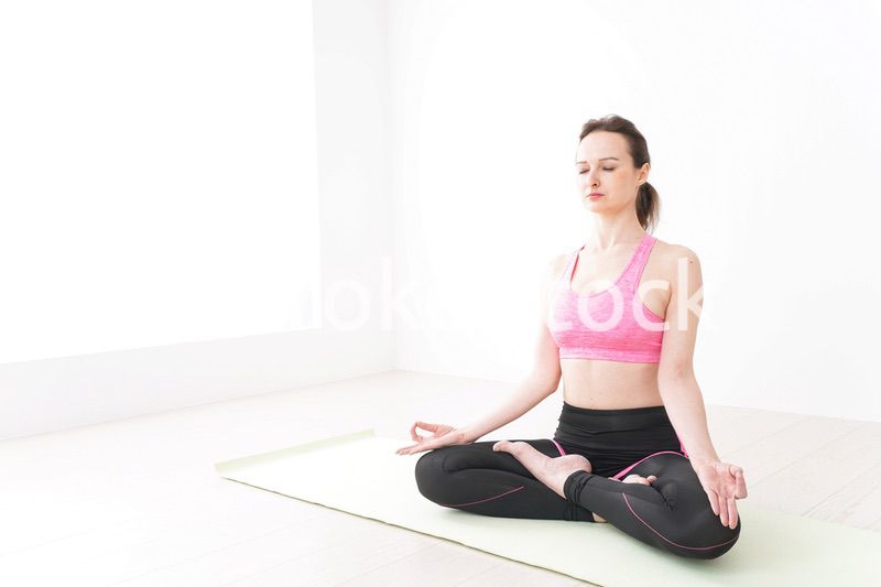 スポーツウェアを着てヨガをする外国人の女性