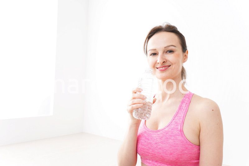 スポーツウェアを着て水分補給をする外国人の女性