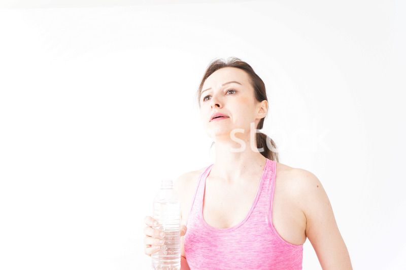 スポーツウェアを着て水分補給をする外国人の女性