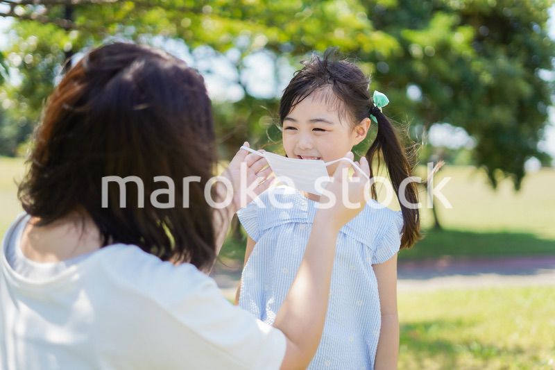子どもにマスクを付けさせるお母さん