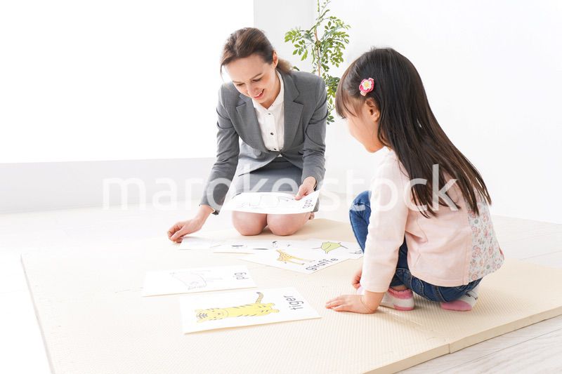 英語教室でネイティブ教師の授業を受ける子ども