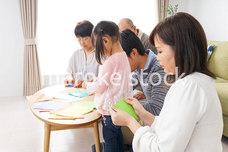 折り紙で遊ぶ子供と家族