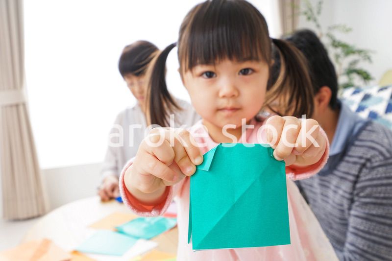 折り紙で遊ぶ子供と家族