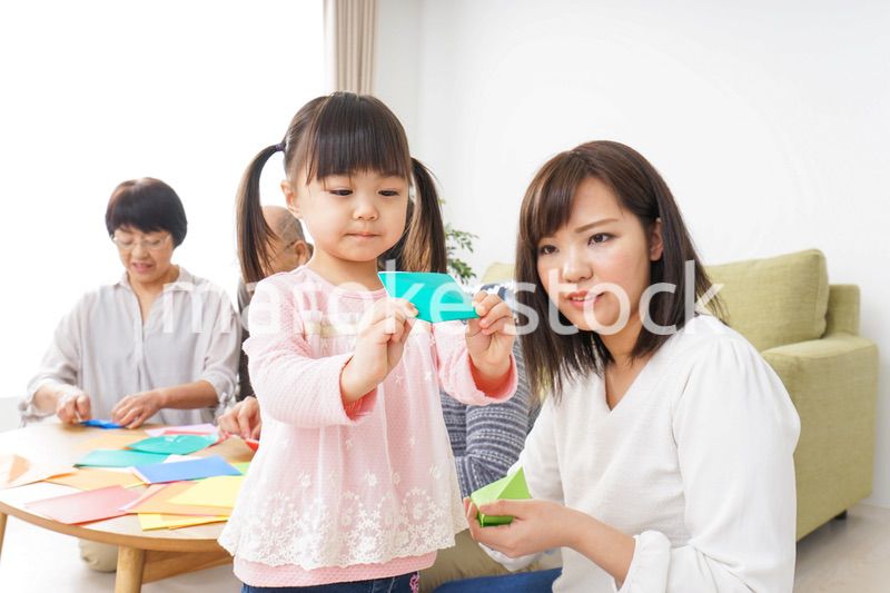 折り紙で遊ぶ子供と家族