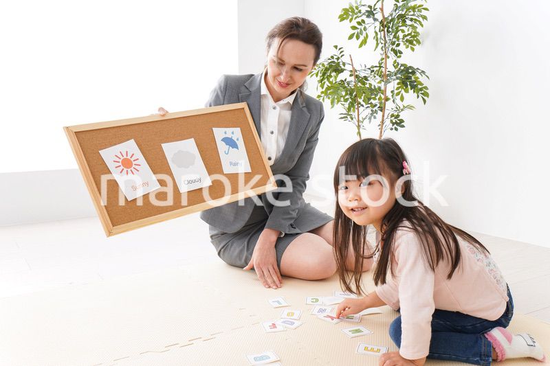 英語教室でネイティブ教師の授業を受ける子ども