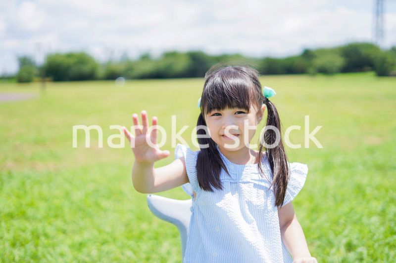 外の遊具で遊ぶ小さな女の子