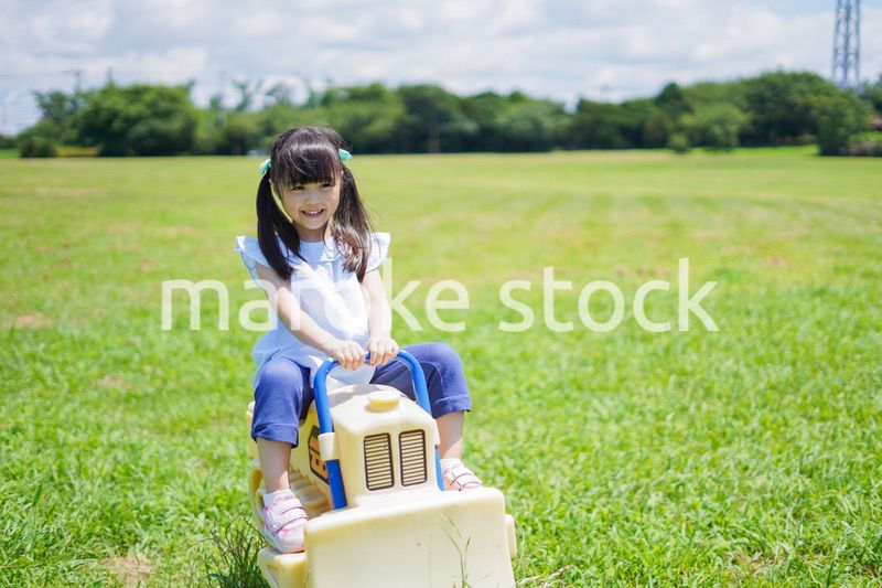 外の遊具で遊ぶ小さな女の子