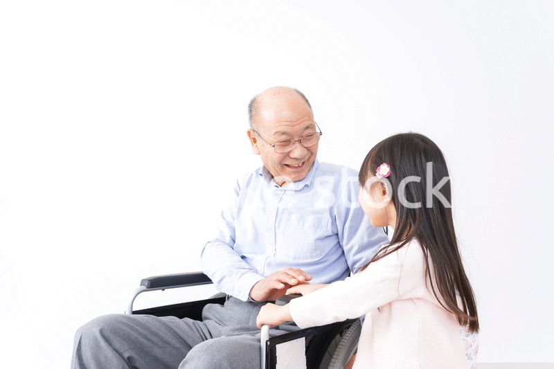 車椅子に乗る高齢男性と女の子
