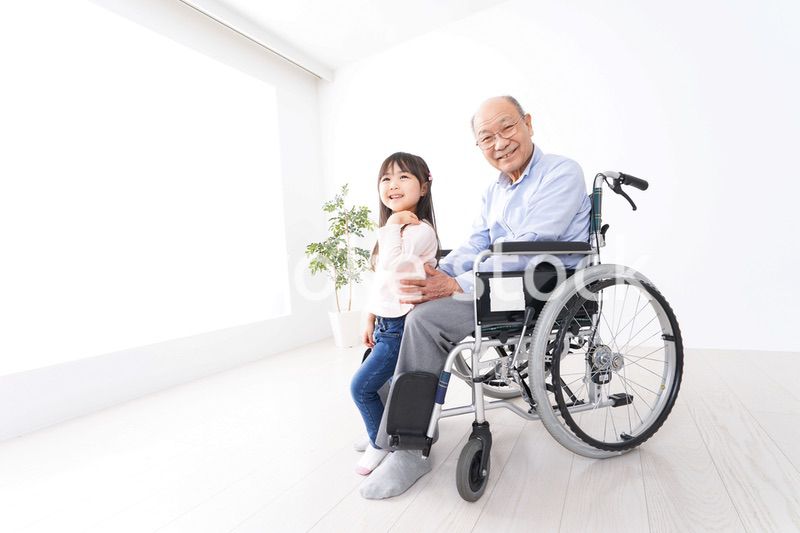 車椅子に乗る高齢男性と女の子
