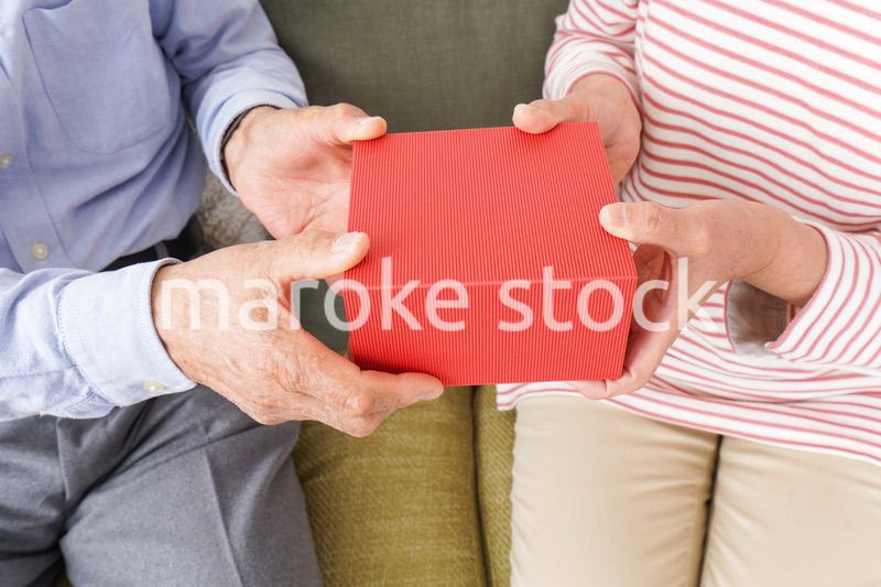 プレゼントを渡す高齢の夫婦