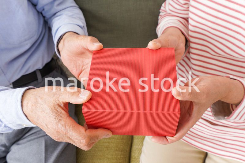 プレゼントを渡す高齢の夫婦