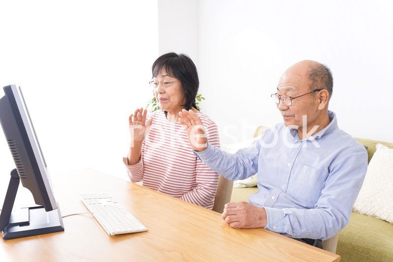 パソコンでテレビ電話をする高齢の夫婦