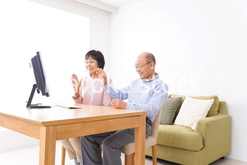 パソコンでテレビ電話をする高齢の夫婦