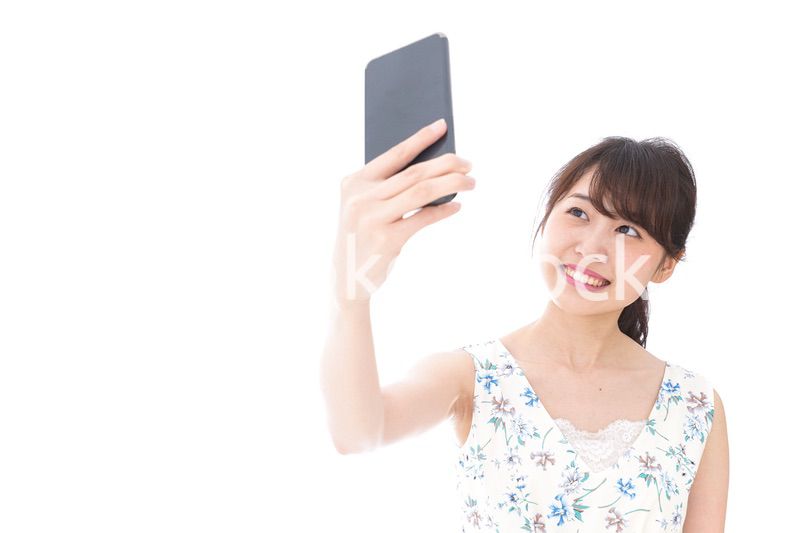 自撮り・ライブ配信をする若い女性