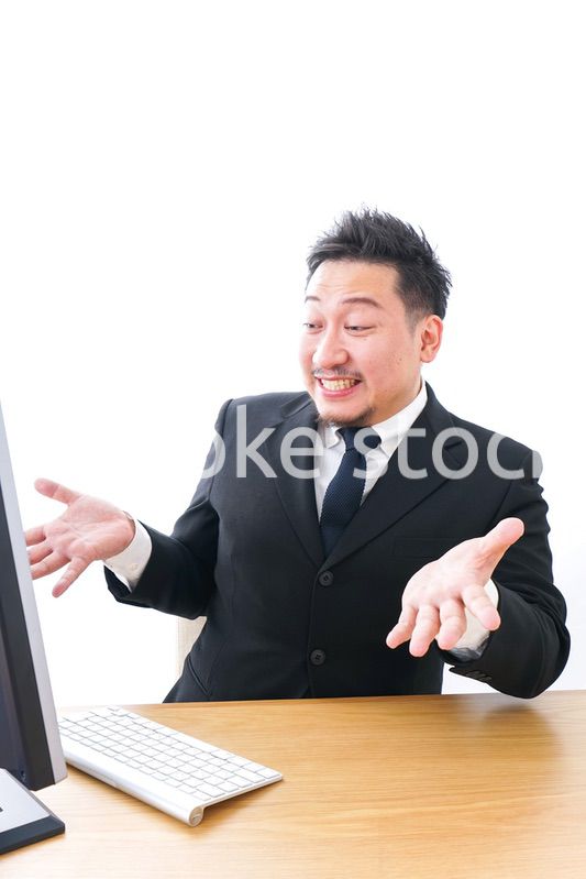 パソコンの前で憤慨するビジネスマン