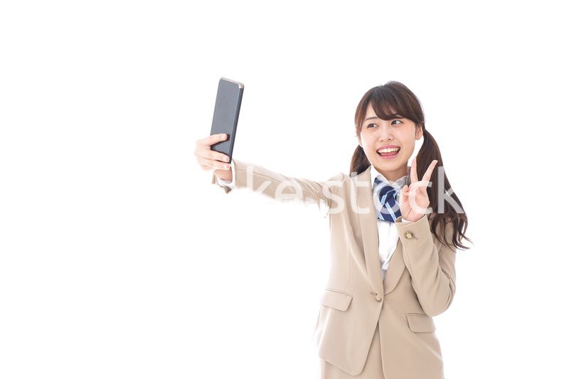 自撮りをする制服姿の学生