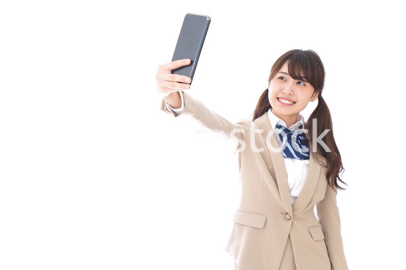 自撮りをする制服姿の学生