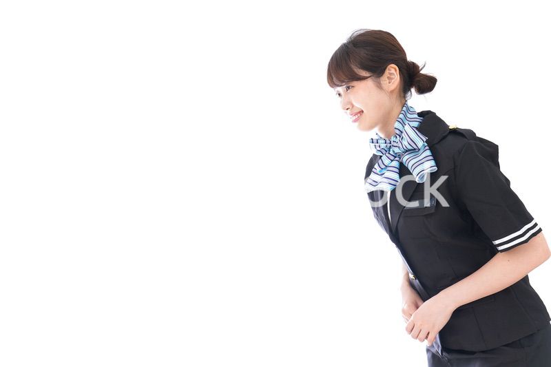お辞儀をするキャビンアテンダント