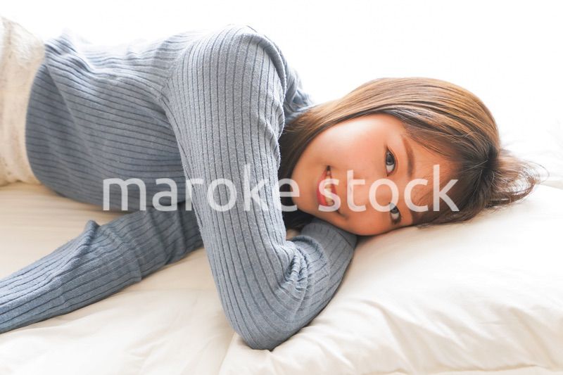 布団に入って睡眠を取る若い女性