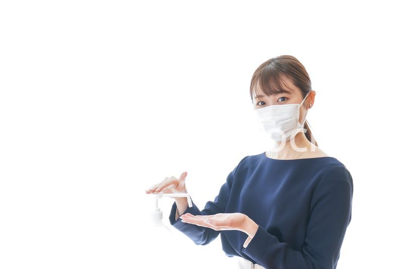 手のアルコール消毒をする若い女性