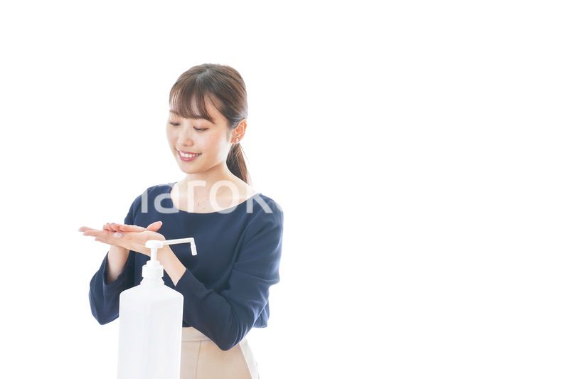 手のアルコール消毒をする若い女性