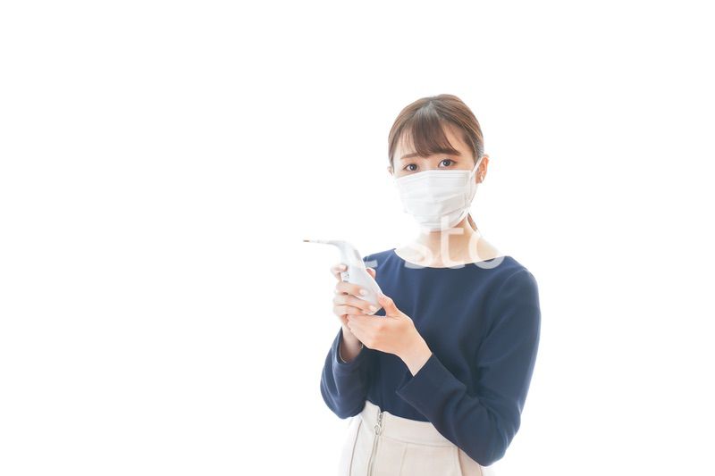 体温の測定をする若いビジネスウーマン