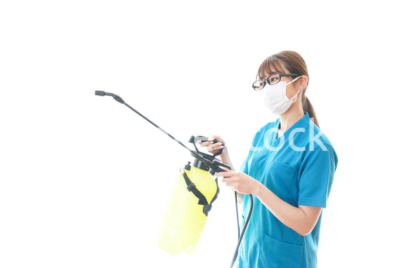 消毒液の噴霧をする医療従事者