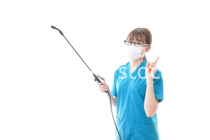 消毒液を持ちアドバイスをする医療従事者