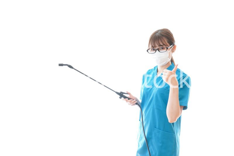 消毒液を持ちアドバイスをする医療従事者