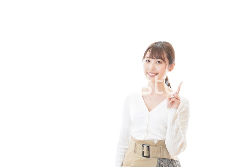 笑顔で指をさす若い女性