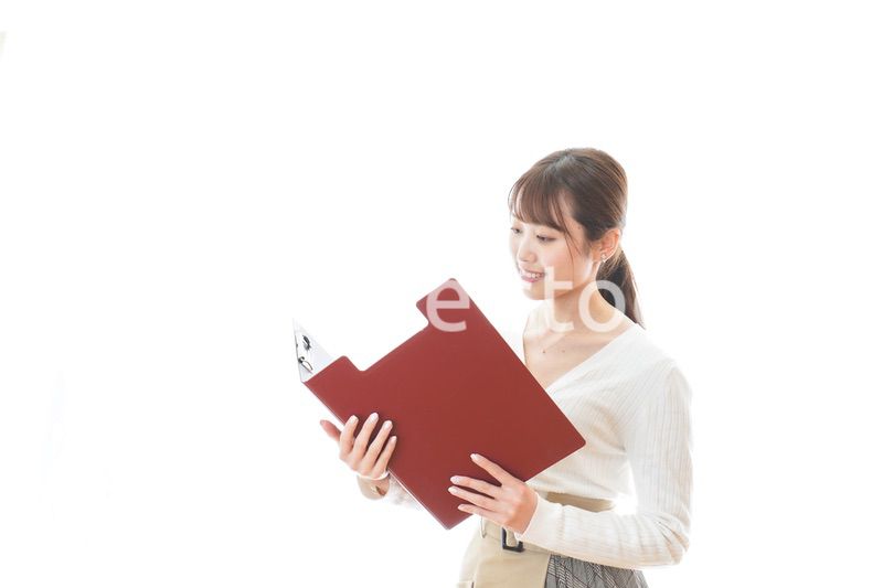 笑顔で資料を持つ若い女性