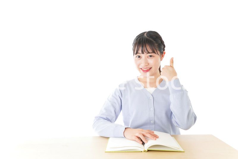 勉強をしながら指を指す若い女子学生