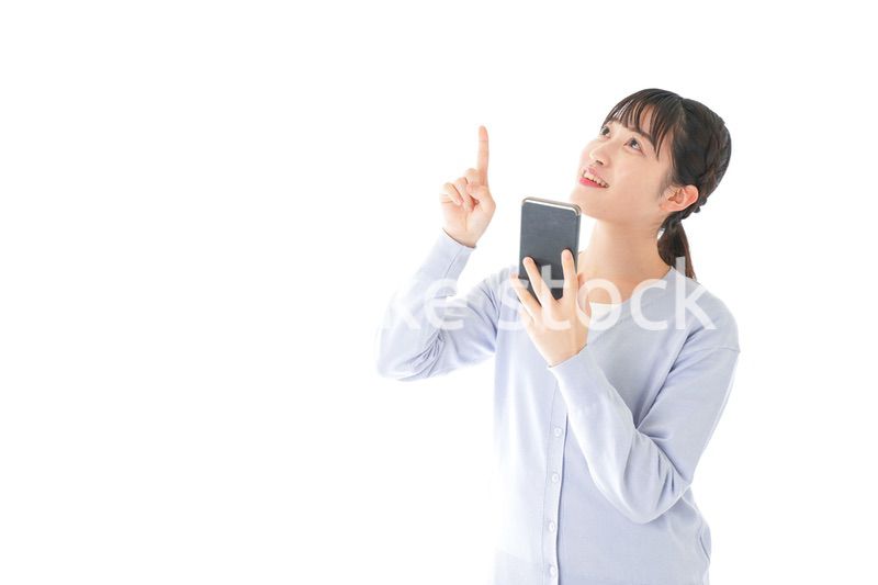 IOT家電をスマホで操作する若い女性