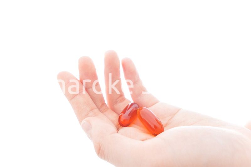 薬・サプリメントを飲む若い女性