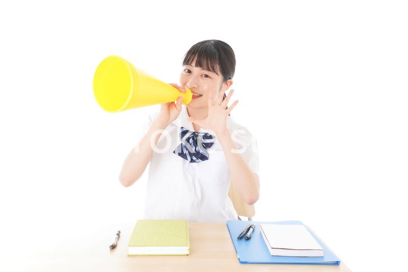 応援をする制服姿の女子学生