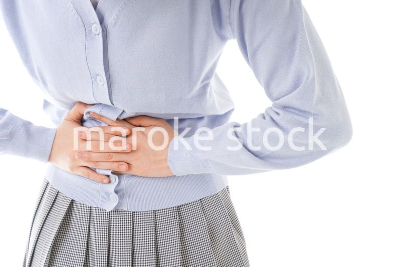 腹痛に苦しむ若い女性