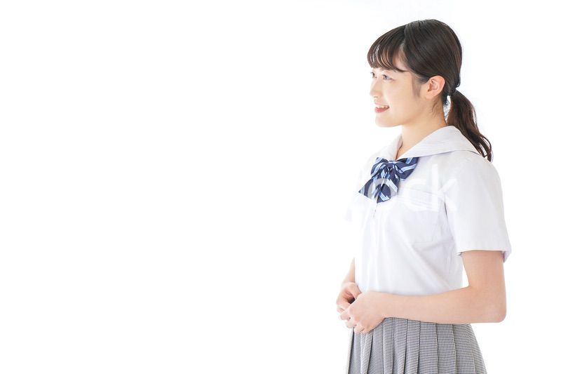 笑顔の若い制服姿の女子学生
