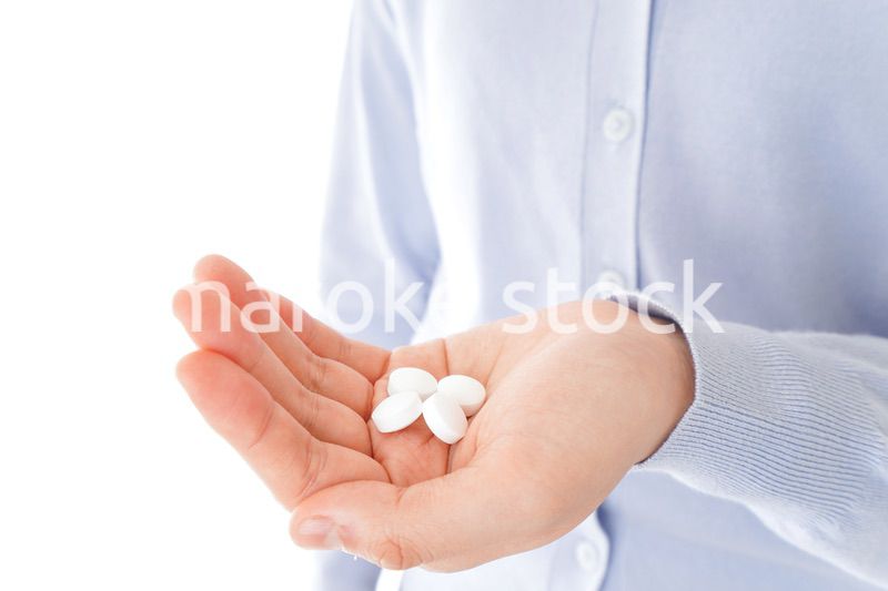 薬・サプリメントを服用する若い女性