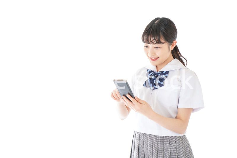 スマートフォンを使う若い女子学生