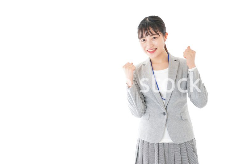 ガッツポーズをする若いキャリアウーマン