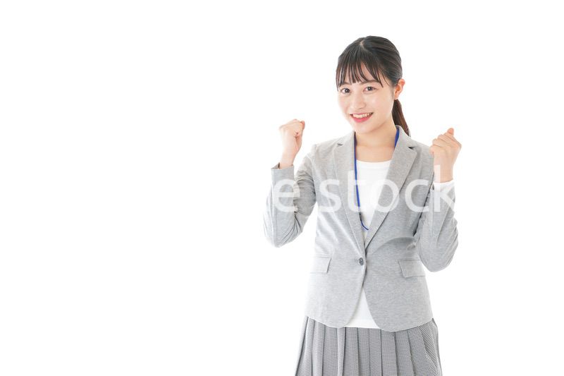 ガッツポーズをする若いキャリアウーマン