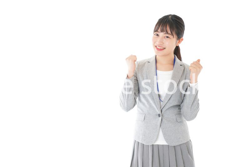 ガッツポーズをする若いキャリアウーマン