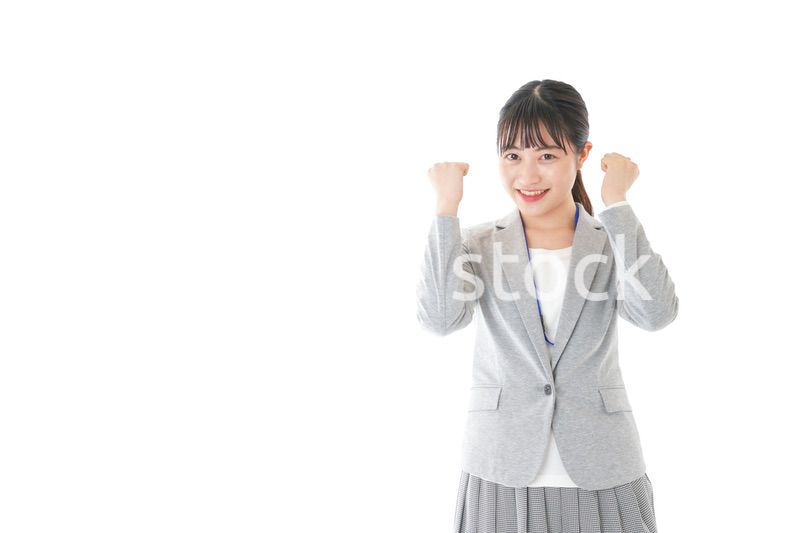 ガッツポーズをする若いキャリアウーマン