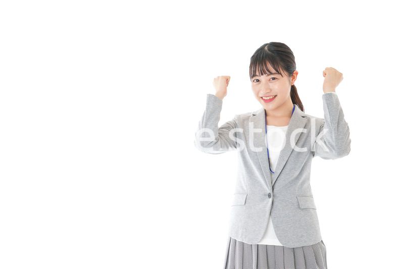 ガッツポーズをする若いキャリアウーマン