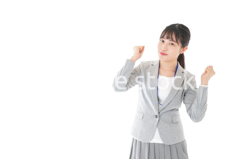 ガッツポーズをする若いキャリアウーマン