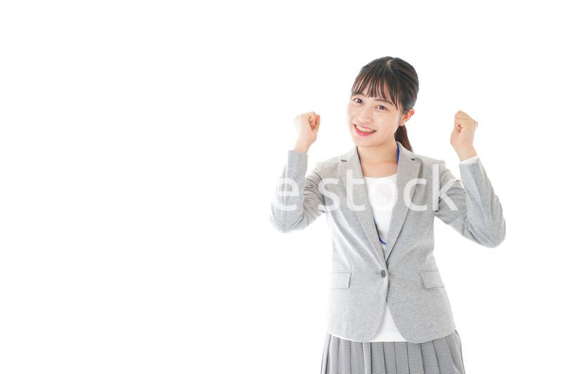 ガッツポーズをする若いキャリアウーマン