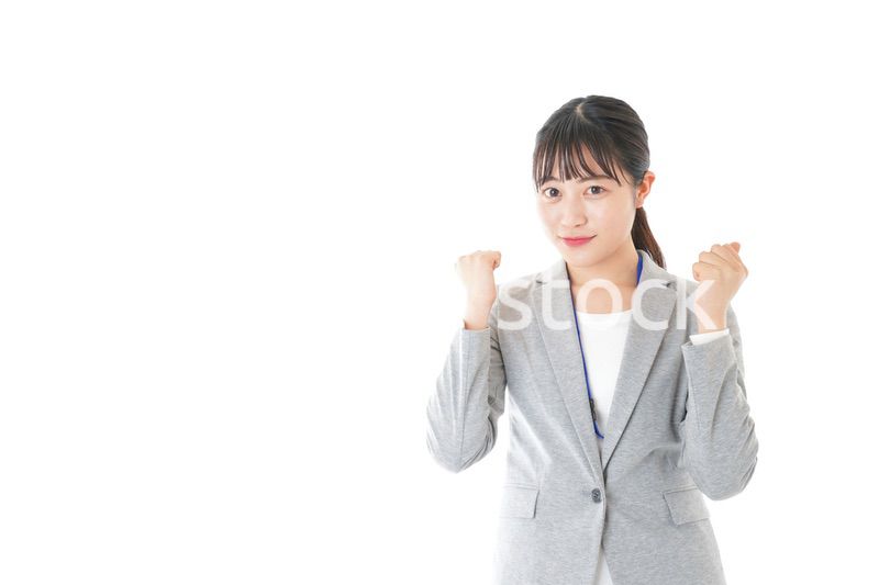 ガッツポーズをする若いキャリアウーマン